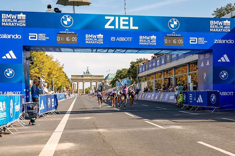 Aubane Plouhinec cheering as she crosses the finish line.