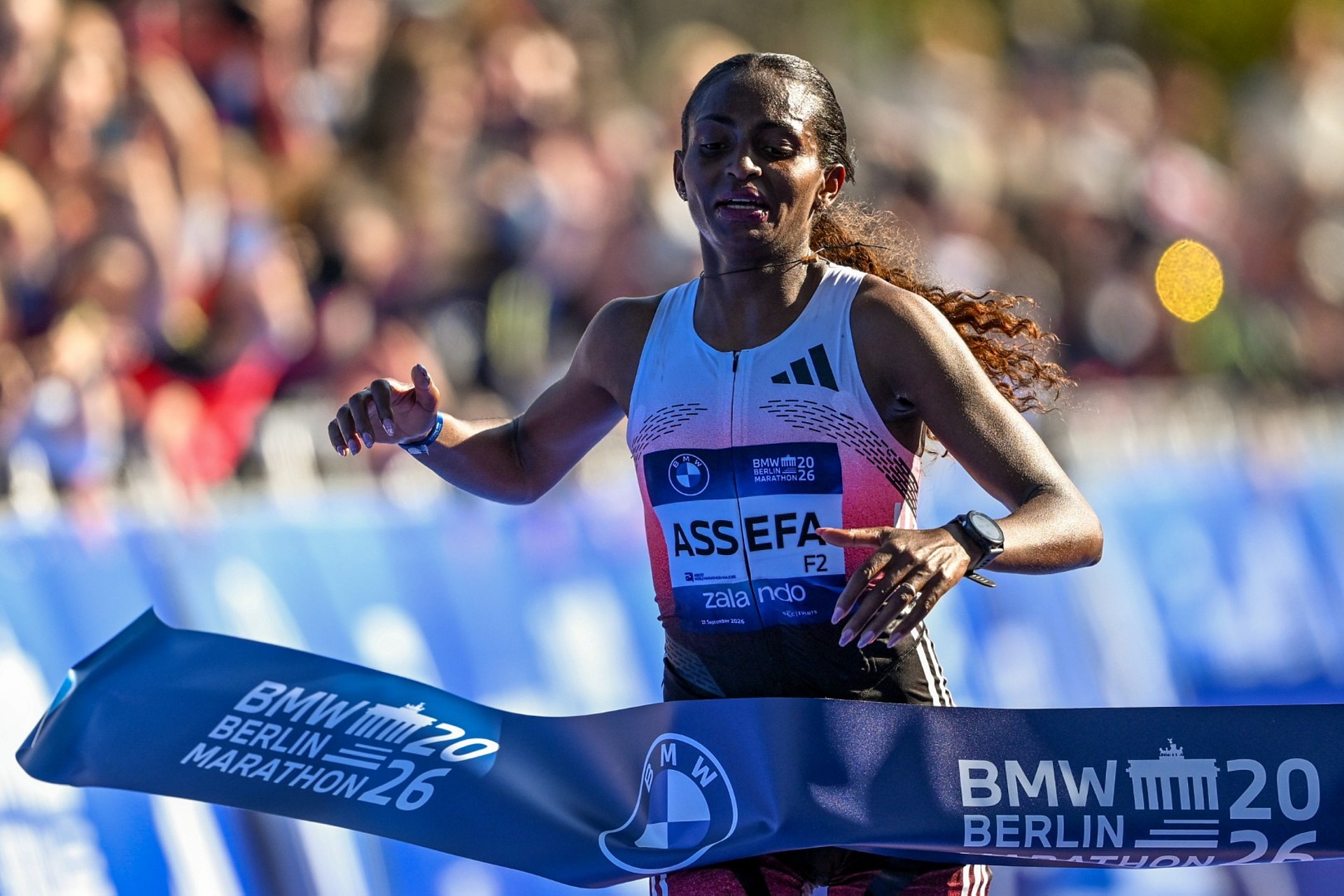Assefa runs across the finish line.