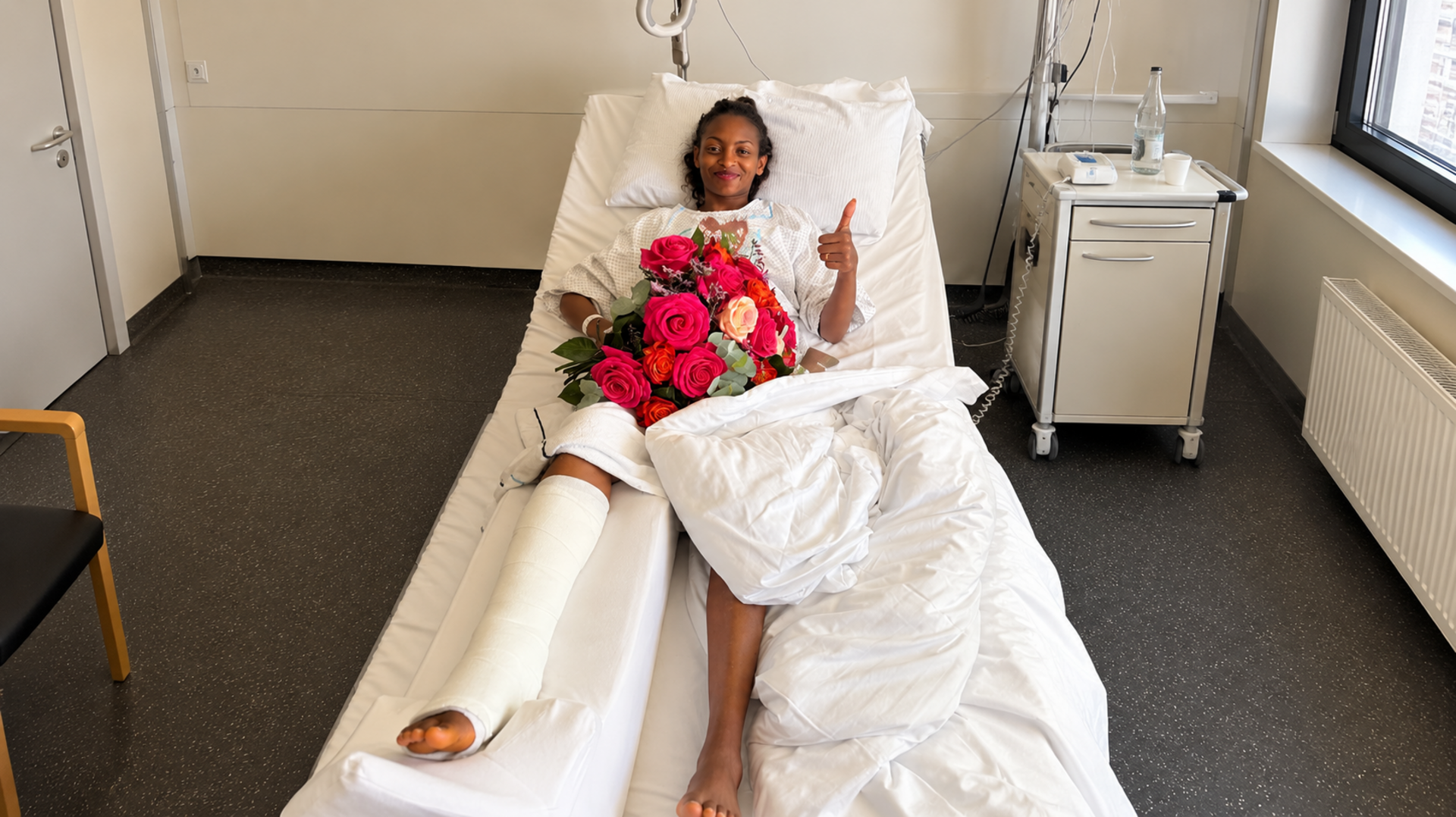 Tigst Assefa in the hospital after surgery (format adjusted from portrait to landscape using AI).
